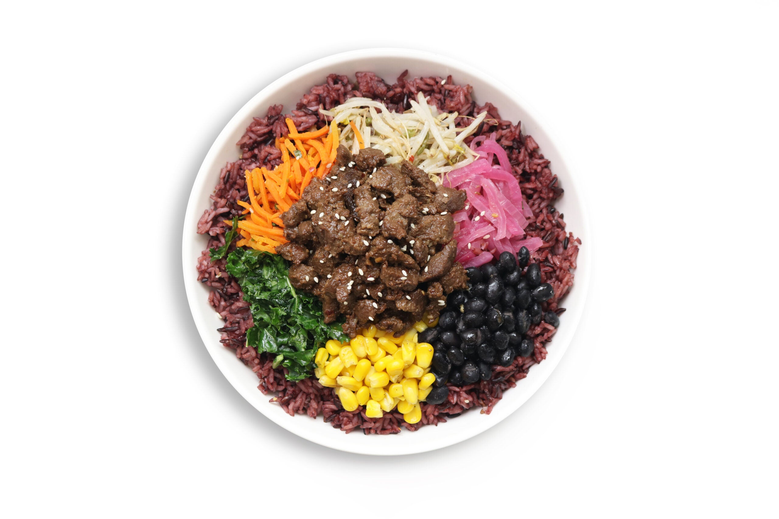 Steak over Purple Rice with Pickled Red Onion, Black Beans, Corn, Carrots, Kale and Bean Sprouts in a BIBIBOP bowl