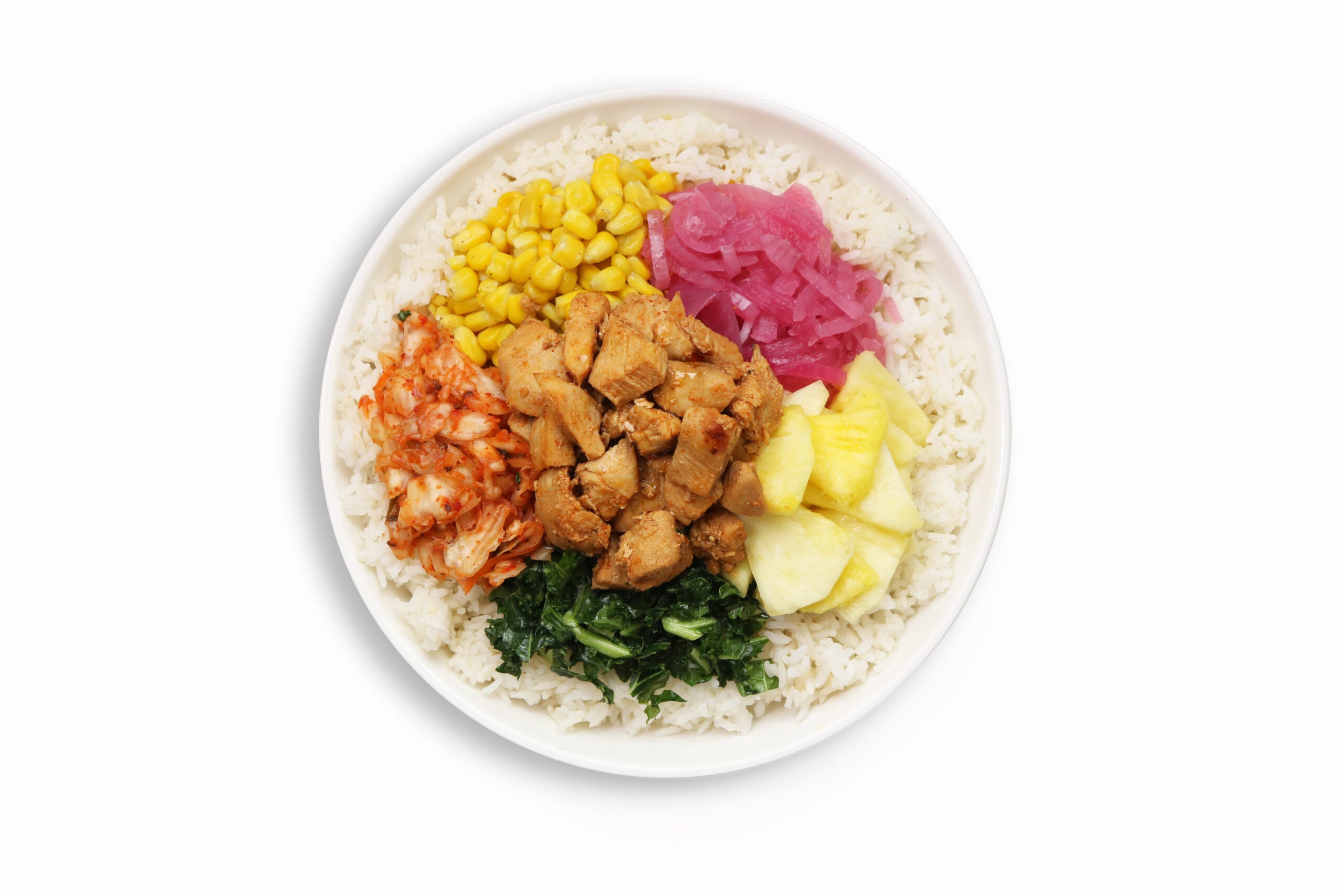 A BIBIBOP Sweet and Spicy Chicken Bowl with White Rice, Kimchi, Pickled Red Onion, Corn and Kale