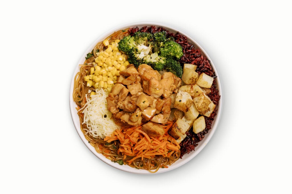 BIBIBOP Fan Favorite Bowl with Chicken, Purple Rice, Sweet Potato Noodles, Roasted Sesame Broccoli, Potatoes, Carrots, Corn, and Cheese, topped with sweet & tangy Yum Yum Sauce.