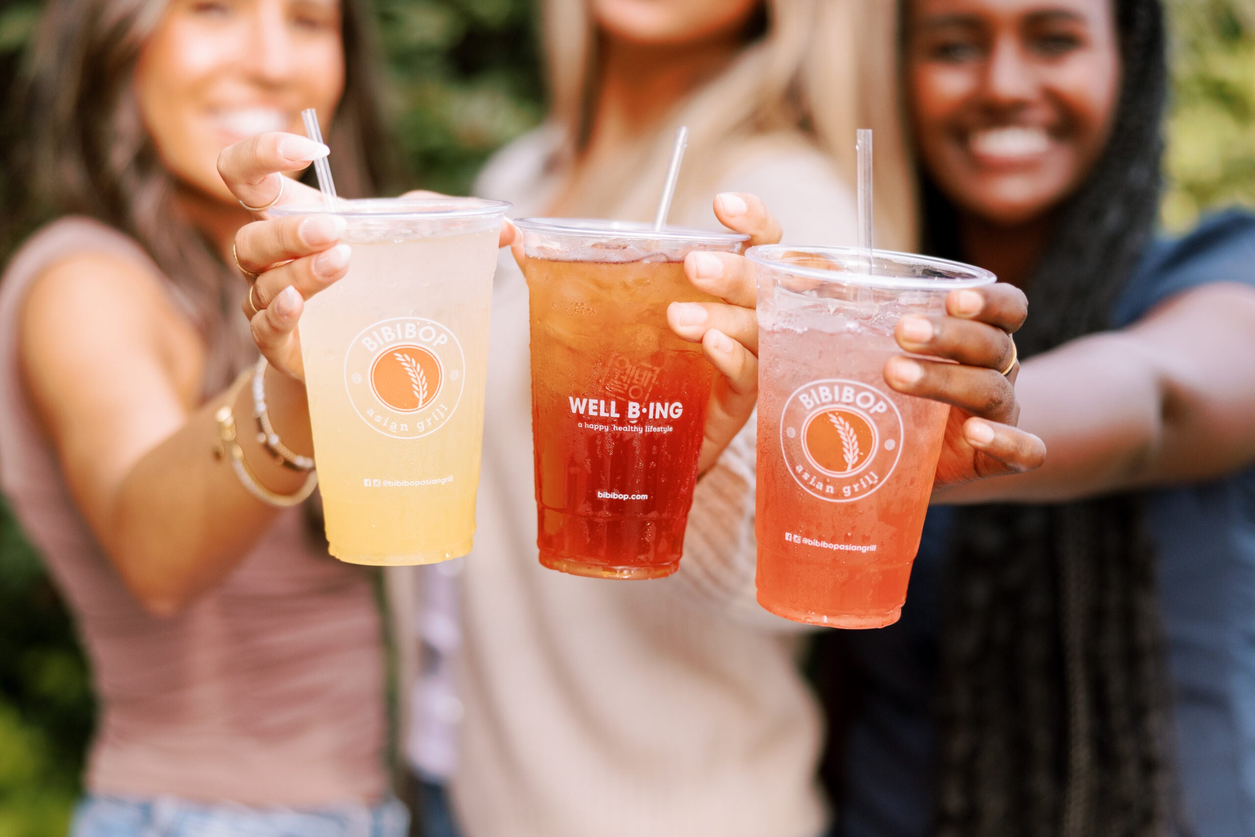3 women holding styled drinks